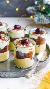 This Christmas Black Forest Trifle is a delightful dessert that combines layers of chocolate cake, rich cream, and cherries.