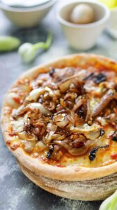 This caramelized onion goat cheese pizza is a delightful combination of sweet and savory flavors, perfect for a gourmet pizza night at home.