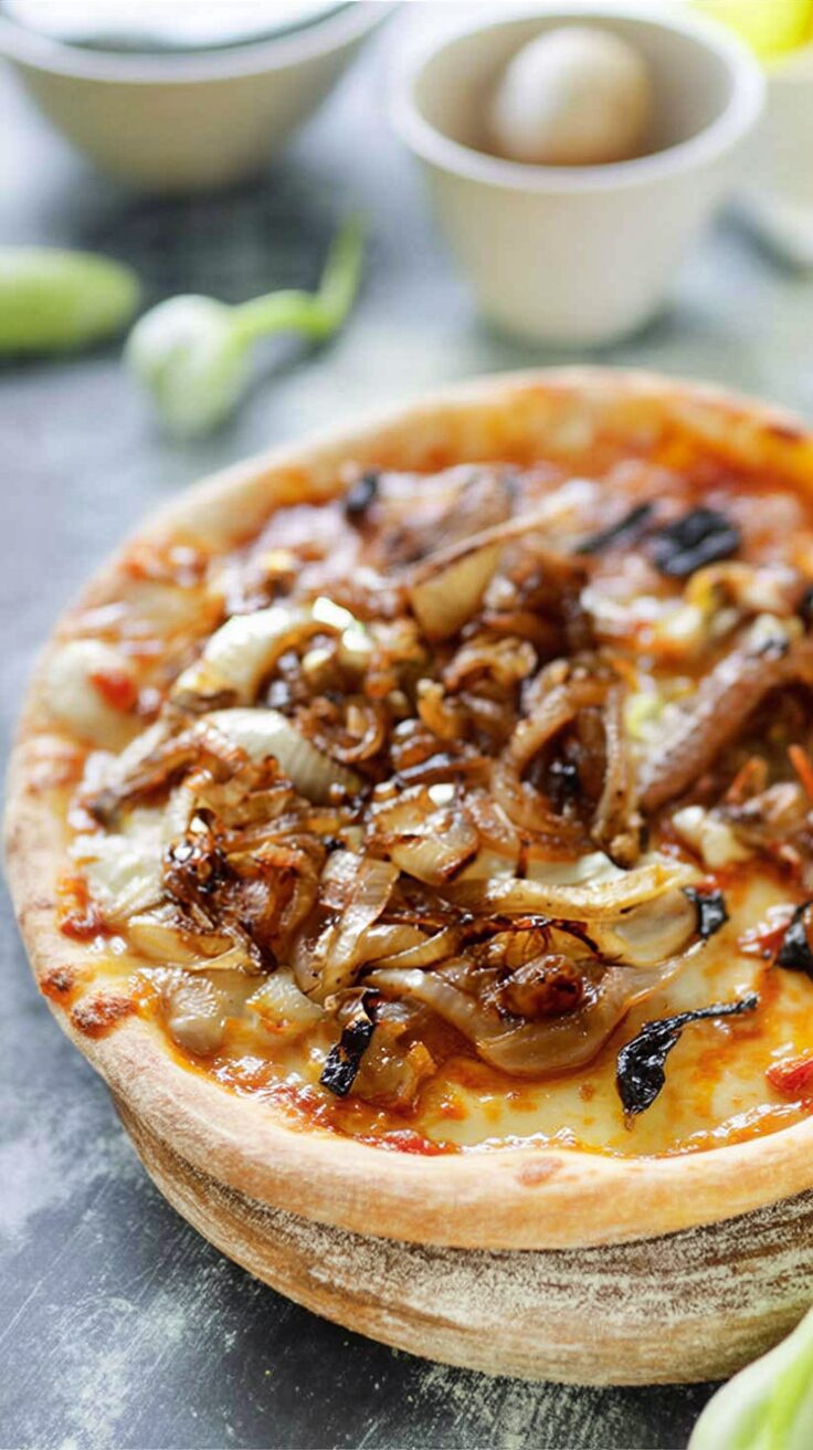 This caramelized onion goat cheese pizza is a delightful combination of sweet and savory flavors, perfect for a gourmet pizza night at home.