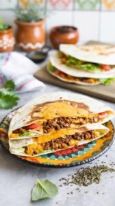 This quesadilla smash burger combines the best of both worlds, featuring a juicy burger patty sandwiched between two crispy quesadillas.